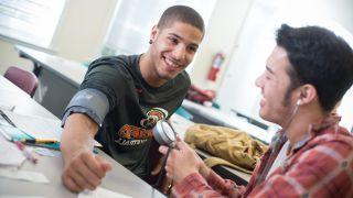 student using stethoscope on athlete